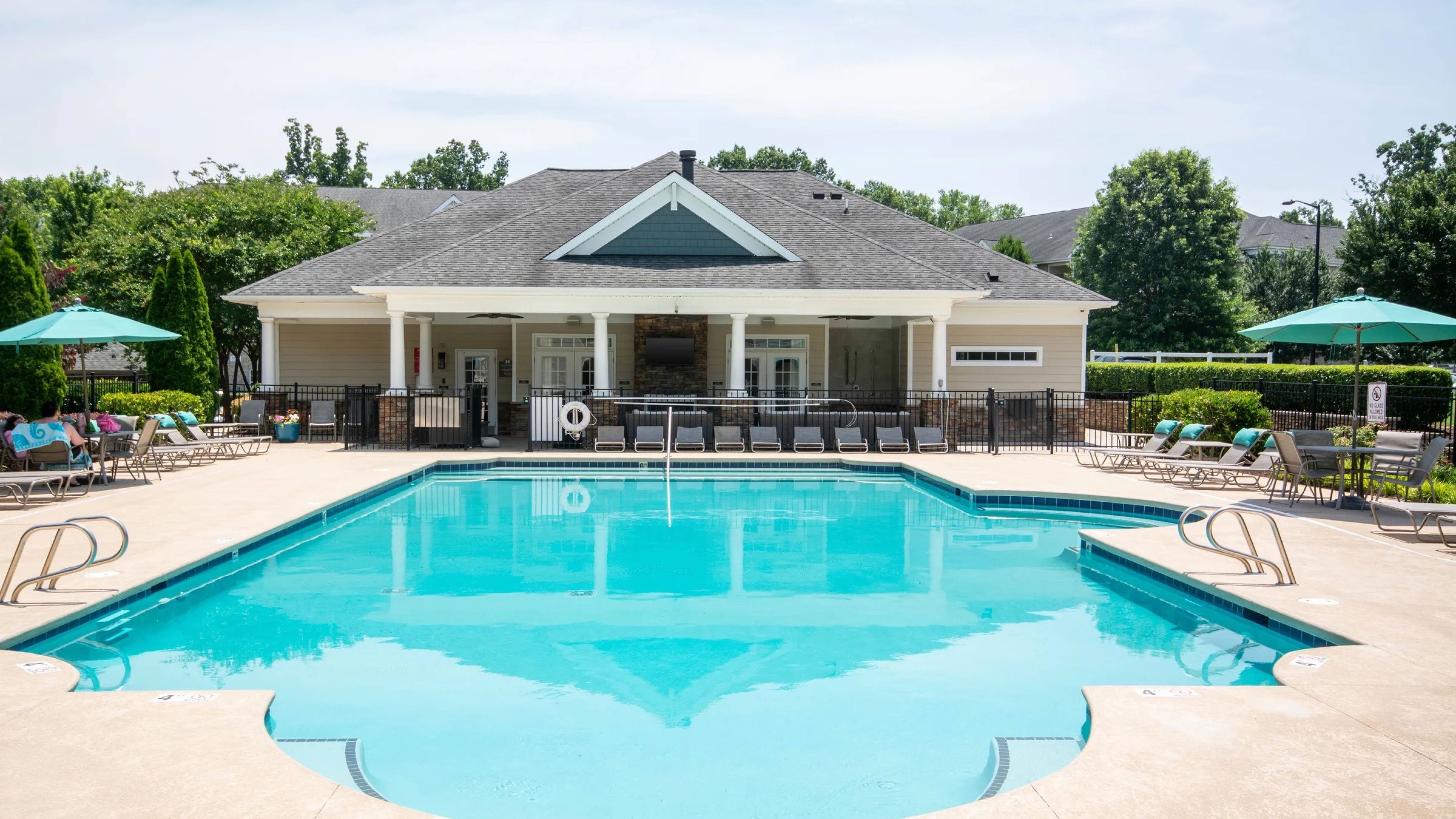 Hawthorne at Horse Pen Creek apartment community exterior and luxury outdoor pool with lounge chairs and surrounding seating